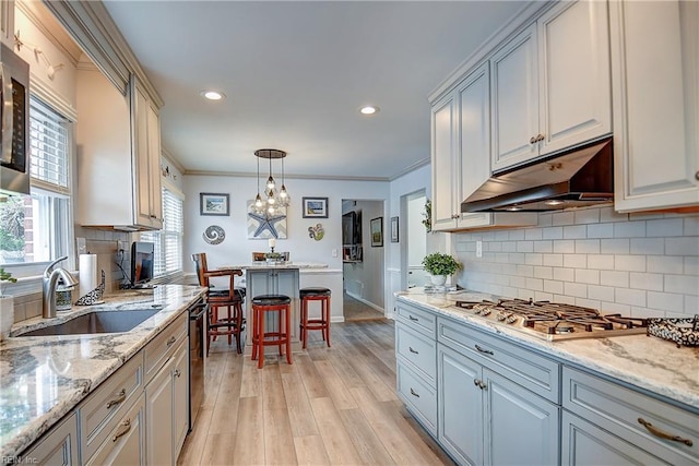 1052 Sunnyside Dr, Virginia Beach, VA 23464 - kitchen with under cabinet range hood, a sink, appliances with stainless steel finishes, light wood-type flooring, and recessed lighting