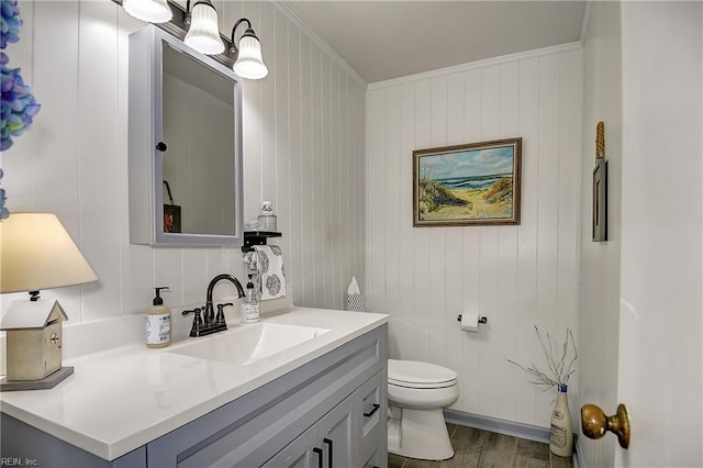 1052 Sunnyside Dr, Virginia Beach, VA 23464 - bathroom with vanity, wood finished floors, toilet, and ornamental molding