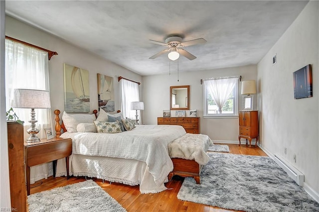 1052 Sunnyside Dr, Virginia Beach, VA 23464 - bedroom with a baseboard heating unit, wood finished floors, ceiling fan, and baseboards