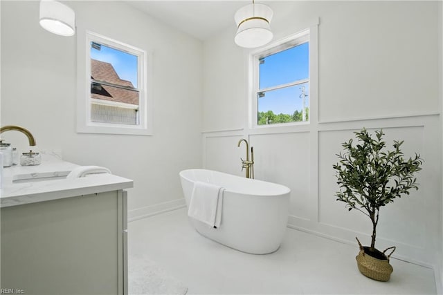 1653 Shipyard Rd, Chesapeake, VA 23323 - full bathroom with a decorative wall, a freestanding tub, plenty of natural light, vanity, and a wainscoted wall