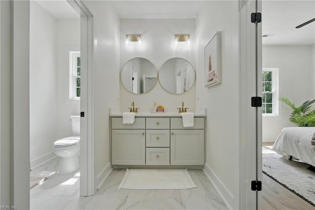1653 Shipyard Rd, Chesapeake, VA 23323 - ensuite bathroom with double vanity, marble look tile flooring, toilet, and baseboards