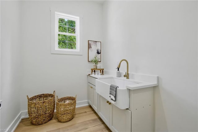 1653 Shipyard Rd, Chesapeake, VA 23323 - laundry room with a sink, light wood finished floors, and baseboards