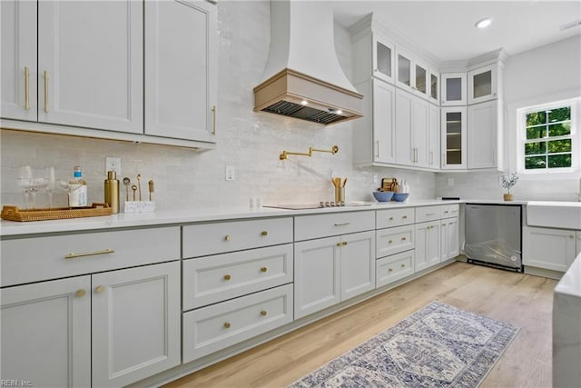 1653 Shipyard Rd, Chesapeake, VA 23323 - kitchen featuring dishwasher, premium range hood, light countertops, tasteful backsplash, and black electric cooktop
