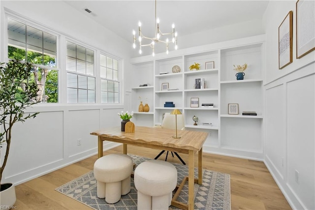 1653 Shipyard Rd, Chesapeake, VA 23323 - office area featuring light wood-style floors, built in features, a chandelier, and a decorative wall