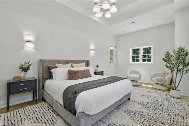 1653 Shipyard Rd, Chesapeake, VA 23323 - bedroom with a chandelier, wood finished floors, and baseboards