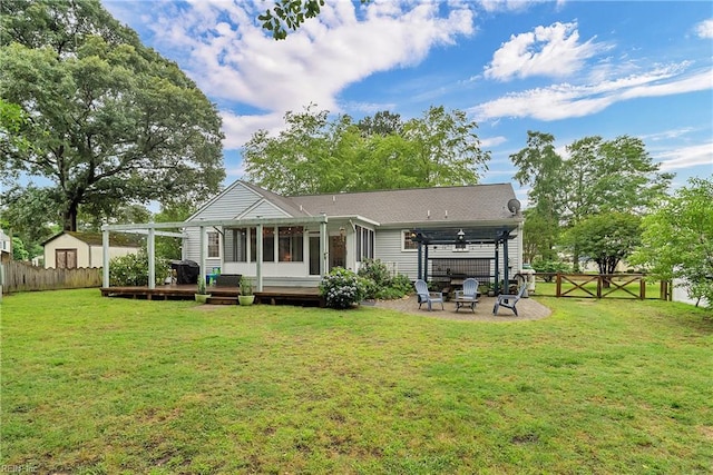 2305 Shorebird Ct, Chesapeake, VA 23323 - back of property with a wooden deck, a sunroom, an outdoor fire pit, and a pergola