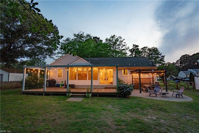2305 Shorebird Ct, Chesapeake, VA 23323 - back of house at dusk with a fire pit, a wooden deck, a pergola, and a patio