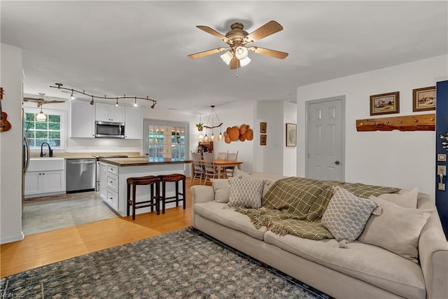 2305 Shorebird Ct, Chesapeake, VA 23323 - living room featuring ceiling fan and a chandelier