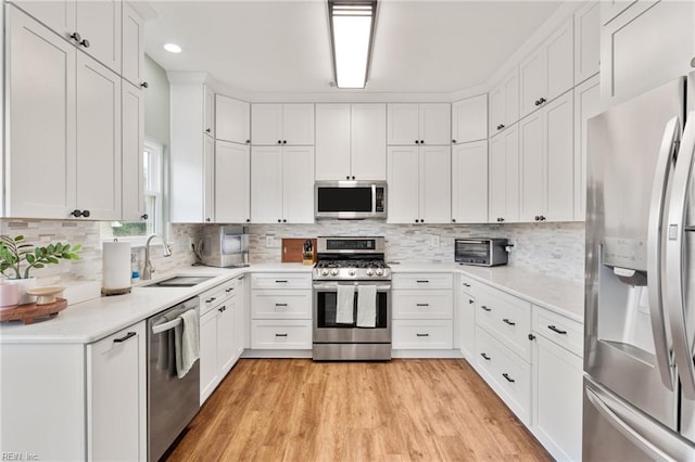 433 Fall Ridge Ln, Chesapeake, VA 23322 - kitchen with appliances with stainless steel finishes, a sink, light wood-style floors, light countertops, and white cabinets