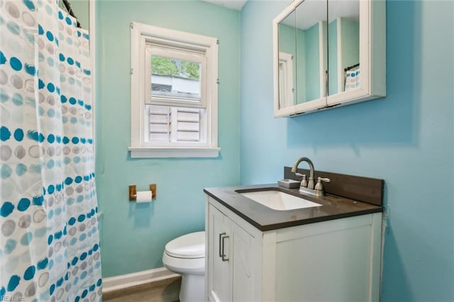 203 Old Seaford Rd, Seaford, VA 23696 - full bathroom with vanity, toilet, baseboards, curtained shower, and wood finished floors