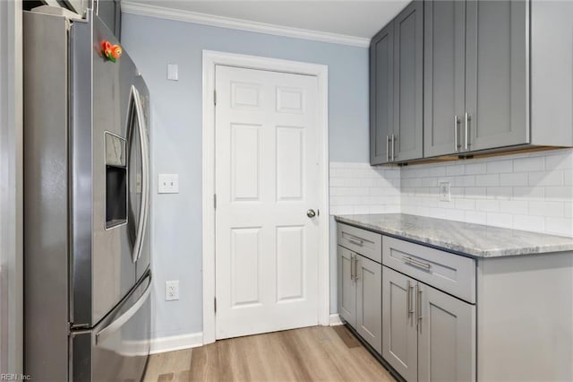 203 Old Seaford Rd, Seaford, VA 23696 - kitchen featuring stainless steel fridge with ice dispenser, gray cabinetry, light wood-style floors, ornamental molding, and tasteful backsplash