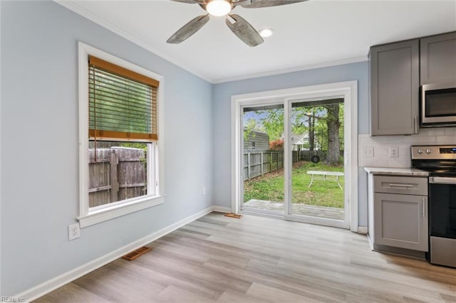 203 Old Seaford Rd, Seaford, VA 23696 - kitchen featuring appliances with stainless steel finishes, gray cabinets, crown molding, a ceiling fan, and light wood-style floors
