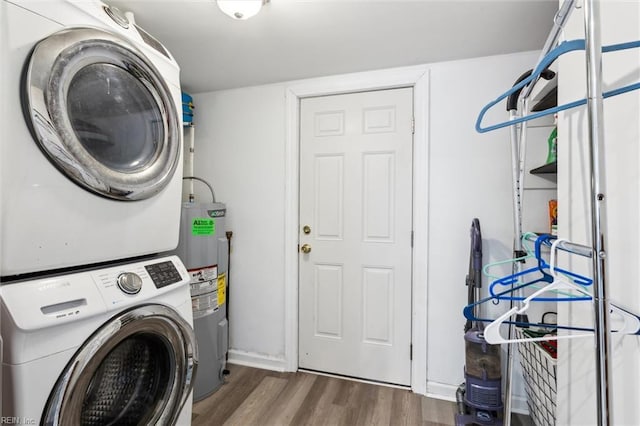 203 Old Seaford Rd, Seaford, VA 23696 - washroom with stacked washing machine and dryer, wood finished floors, water heater, and baseboards