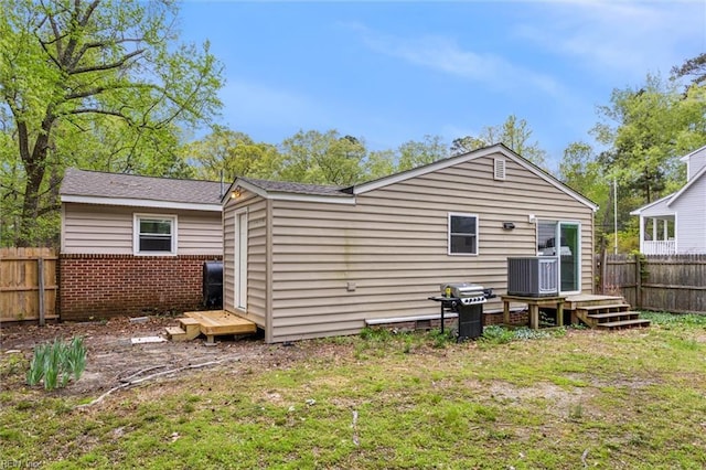 203 Old Seaford Rd, Seaford, VA 23696 - back of house with central AC, a wooden deck, an outdoor structure, and brick siding
