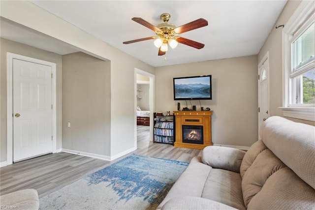 203 Old Seaford Rd, Seaford, VA 23696 - living room with wood finished floors, a ceiling fan, baseboards, and a glass covered fireplace