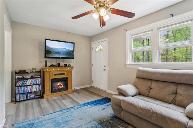 203 Old Seaford Rd, Seaford, VA 23696 - living area with wood finished floors, baseboards, a glass covered fireplace, and a ceiling fan