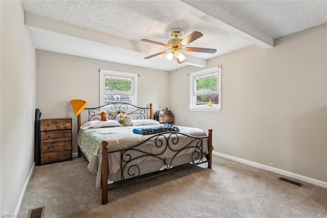 203 Old Seaford Rd, Seaford, VA 23696 - carpeted bedroom with multiple windows, baseboards, beam ceiling, a textured ceiling, and ceiling fan