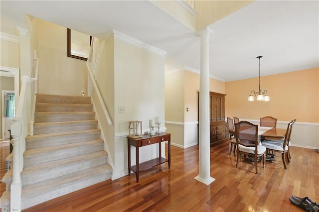 3234 Bentham Ln, Chesapeake, VA 23321 - stairs featuring wood finished floors, crown molding, ornate columns, and a chandelier