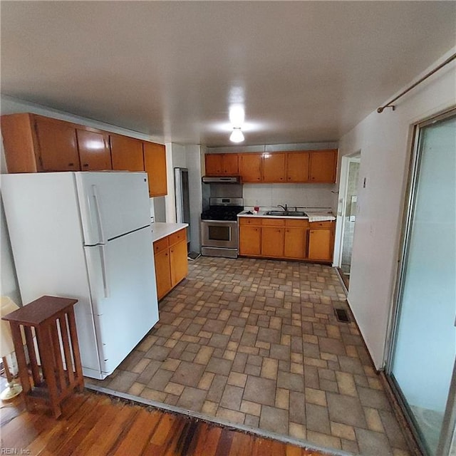 2013 Egger Cir, Hampton, VA 23663 - kitchen featuring stainless steel range, freestanding refrigerator, a sink, light countertops, and brown cabinetry