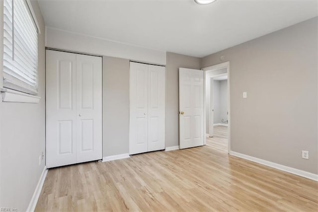 500 Mango Dr, Virginia Beach, VA 23452 - unfurnished bedroom with baseboards, light wood-style flooring, and multiple closets