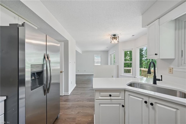 1518 River Creek Cres, Suffolk, VA 23434 - kitchen featuring stainless steel fridge with ice dispenser, a sink, a textured ceiling, and white cabinetry