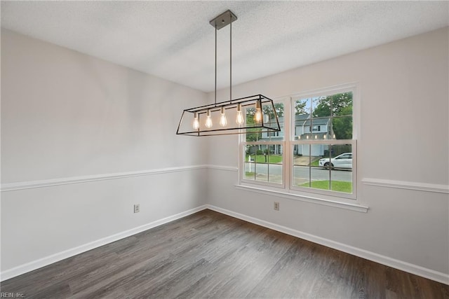 1518 River Creek Cres, Suffolk, VA 23434 - unfurnished dining area featuring dark wood-style flooring, baseboards, a textured ceiling, and a chandelier