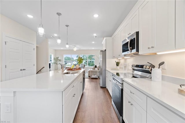 706 Fishermans Rd, Norfolk, VA 23503 - kitchen featuring stainless steel appliances, a sink, white cabinets, recessed lighting, and light countertops