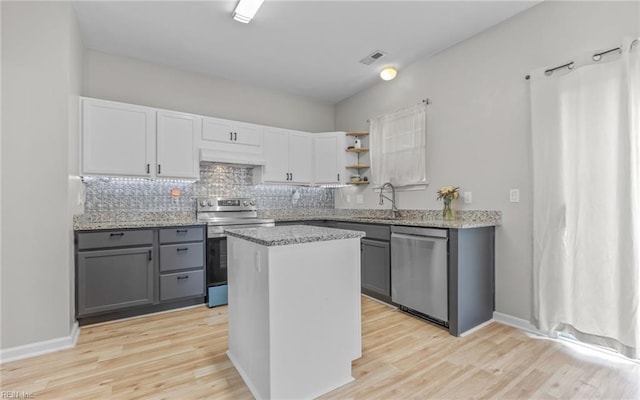 6329 Pelican Cres S, Suffolk, VA 23435 - kitchen with appliances with stainless steel finishes, a sink, gray cabinets, under cabinet range hood, and light wood-style floors