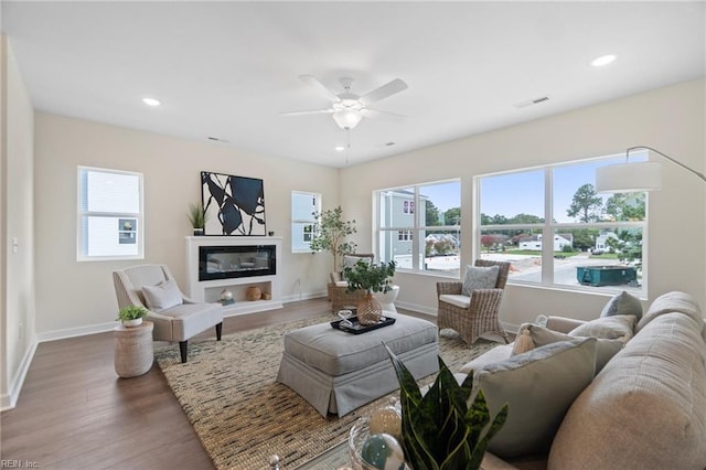 708 Fishermans Rd, Norfolk, VA 23503 - living area featuring wood finished floors, baseboards, ceiling fan, a glass covered fireplace, and recessed lighting