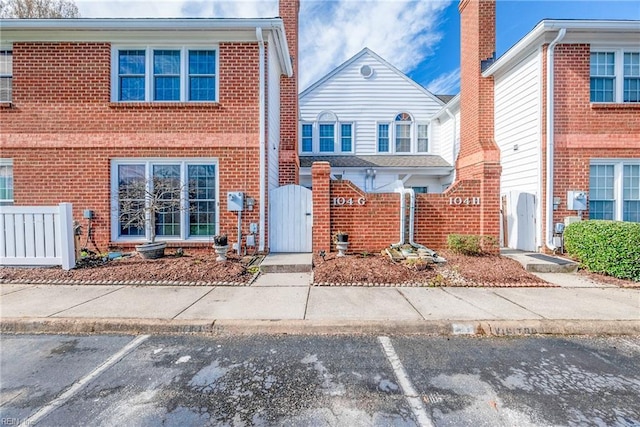 104 Camden Way Unit G, Yorktown, VA 23693 - view of front of house with a gate, uncovered parking, and brick siding