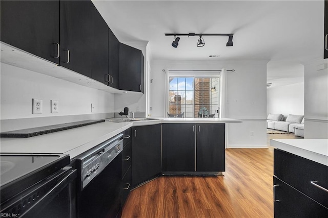 104 Camden Way Unit G, Yorktown, VA 23693 - kitchen with dark cabinetry, black appliances, track lighting, wood finished floors, and open floor plan