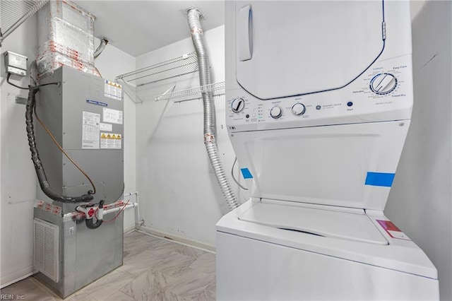 104 Camden Way Unit G, Yorktown, VA 23693 - laundry area with stacked washer and clothes dryer, light marble finish flooring, heating unit, and baseboards