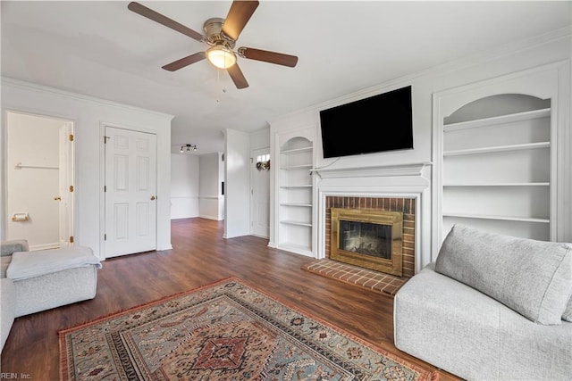 104 Camden Way Unit G, Yorktown, VA 23693 - living area featuring built in features, baseboards, a ceiling fan, wood finished floors, and a brick fireplace