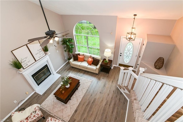 6100 Amberly Cir, Suffolk, VA 23435 - living room with wood finished floors, baseboards, a ceiling fan, high vaulted ceiling, and a glass covered fireplace