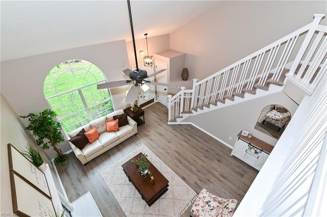 6100 Amberly Cir, Suffolk, VA 23435 - living room featuring wood finished floors, stairway, a ceiling fan, baseboards, and vaulted ceiling