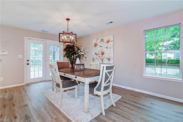 6100 Amberly Cir, Suffolk, VA 23435 - dining space featuring light wood-style floors, baseboards, and a chandelier