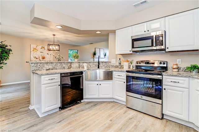 6100 Amberly Cir, Suffolk, VA 23435 - kitchen with appliances with stainless steel finishes, a sink, light wood-style floors, a peninsula, and white cabinets
