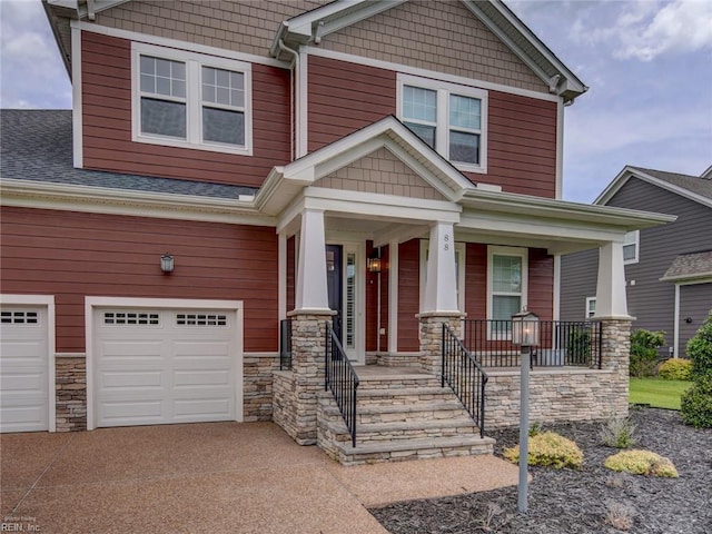 88 Alexandria Way, Carrollton, VA 23314 - craftsman inspired home featuring a garage, driveway, stone siding, covered porch, and a shingled roof