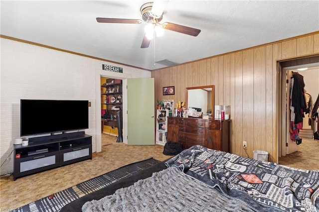 603 Page Dr, Hampton, VA 23669 - bedroom featuring carpet floors, ornamental molding, wood walls, and a ceiling fan