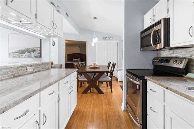 441 Cummings Rd, Virginia Beach, VA 23452 - kitchen with stainless steel appliances, backsplash, vaulted ceiling, white cabinets, and light wood finished floors