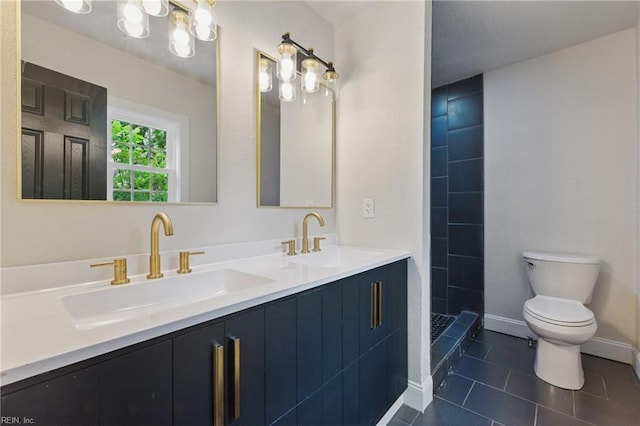 8457 Radnor Rd, Norfolk, VA 23503 - bathroom featuring toilet, double vanity, tile patterned floors, tiled shower, and baseboards