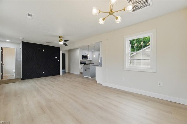 8457 Radnor Rd, Norfolk, VA 23503 - unfurnished living room featuring a chandelier, light wood finished floors, and baseboards