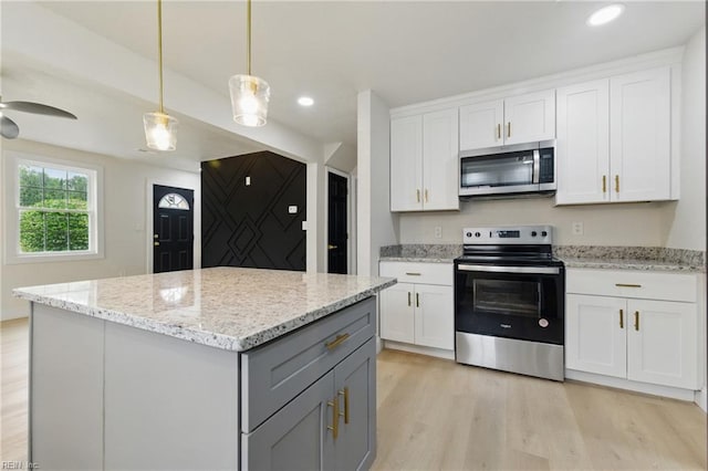 8457 Radnor Rd, Norfolk, VA 23503 - kitchen with stainless steel appliances, light wood finished floors, gray cabinetry, white cabinets, and a kitchen island