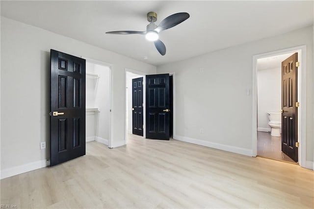 8457 Radnor Rd, Norfolk, VA 23503 - unfurnished bedroom featuring wood finished floors, baseboards, a walk in closet, ensuite bathroom, and a ceiling fan