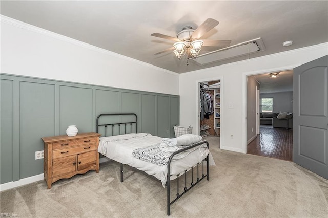 940 Blackwater Rd, Chesapeake, VA 23322 - bedroom with attic access, a decorative wall, light colored carpet, crown molding, and a walk in closet
