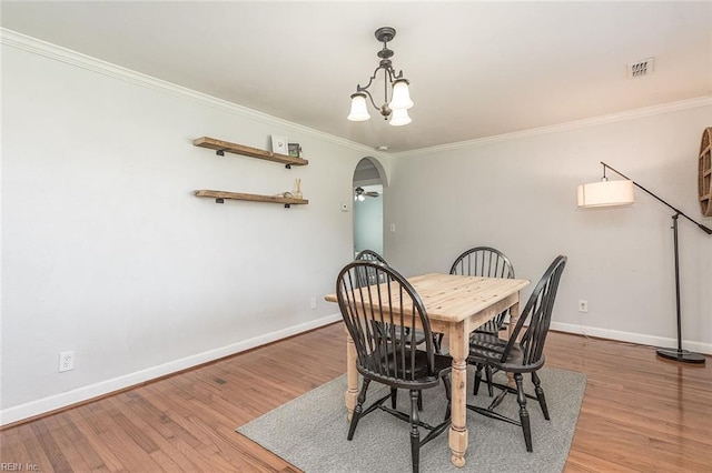 940 Blackwater Rd, Chesapeake, VA 23322 - dining room with arched walkways, baseboards, crown molding, and wood finished floors