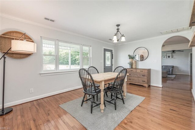 940 Blackwater Rd, Chesapeake, VA 23322 - dining area featuring a chandelier, baseboards, arched walkways, crown molding, and light wood-type flooring