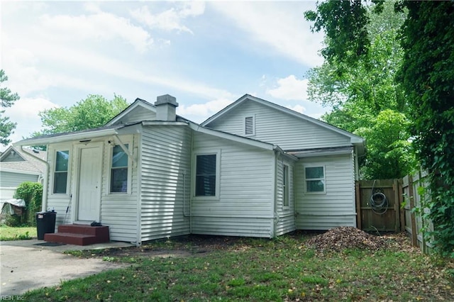 12 Benton Ave, Portsmouth, VA 23702 - rear view of house with a chimney and entry steps