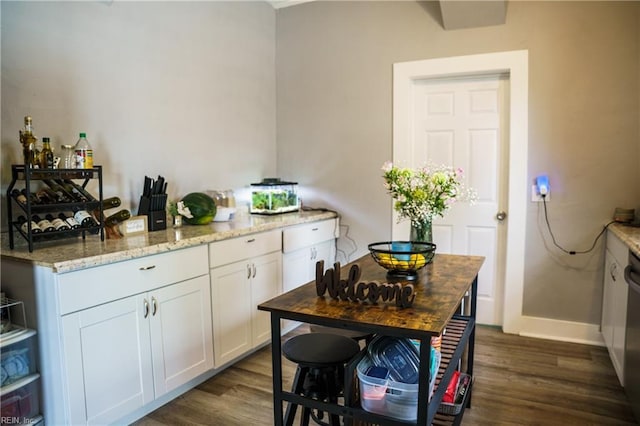 12 Benton Ave, Portsmouth, VA 23702 - kitchen featuring dark wood-type flooring, white cabinetry, light stone countertops, and baseboards