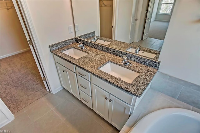 108 Brassy St, Suffolk, VA 23434 - bathroom featuring a spacious closet, double vanity, baseboards, and tile patterned flooring